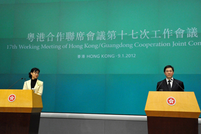 Mr. Lam and Ms. Zhao meet the press after the meeting.