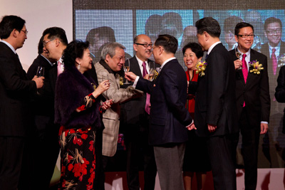 The guests at the event raising a toast on stage.