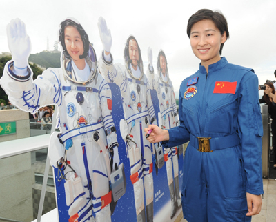 中國首名女太空人劉洋成為市民關注的焦點。她在參觀山頂時,為自己的紙板公仔簽名。