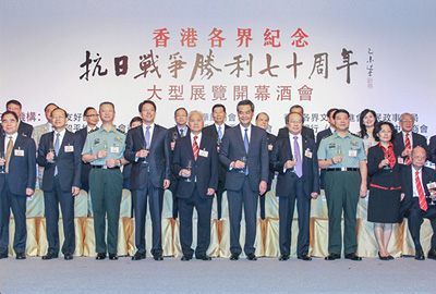 The guests of honour raising a toast on stage.